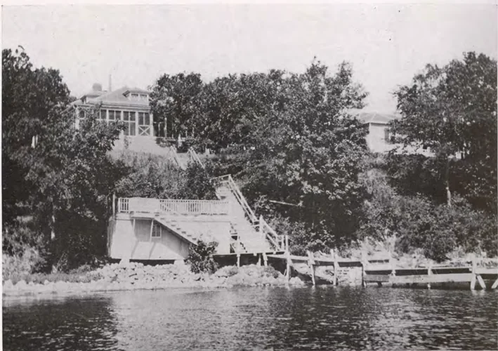 Historic Iowa Lakeside Laboratory buildings above the West Okoboji shoreline, with a boathouse, dock and hillside stairs, published in 1916.
